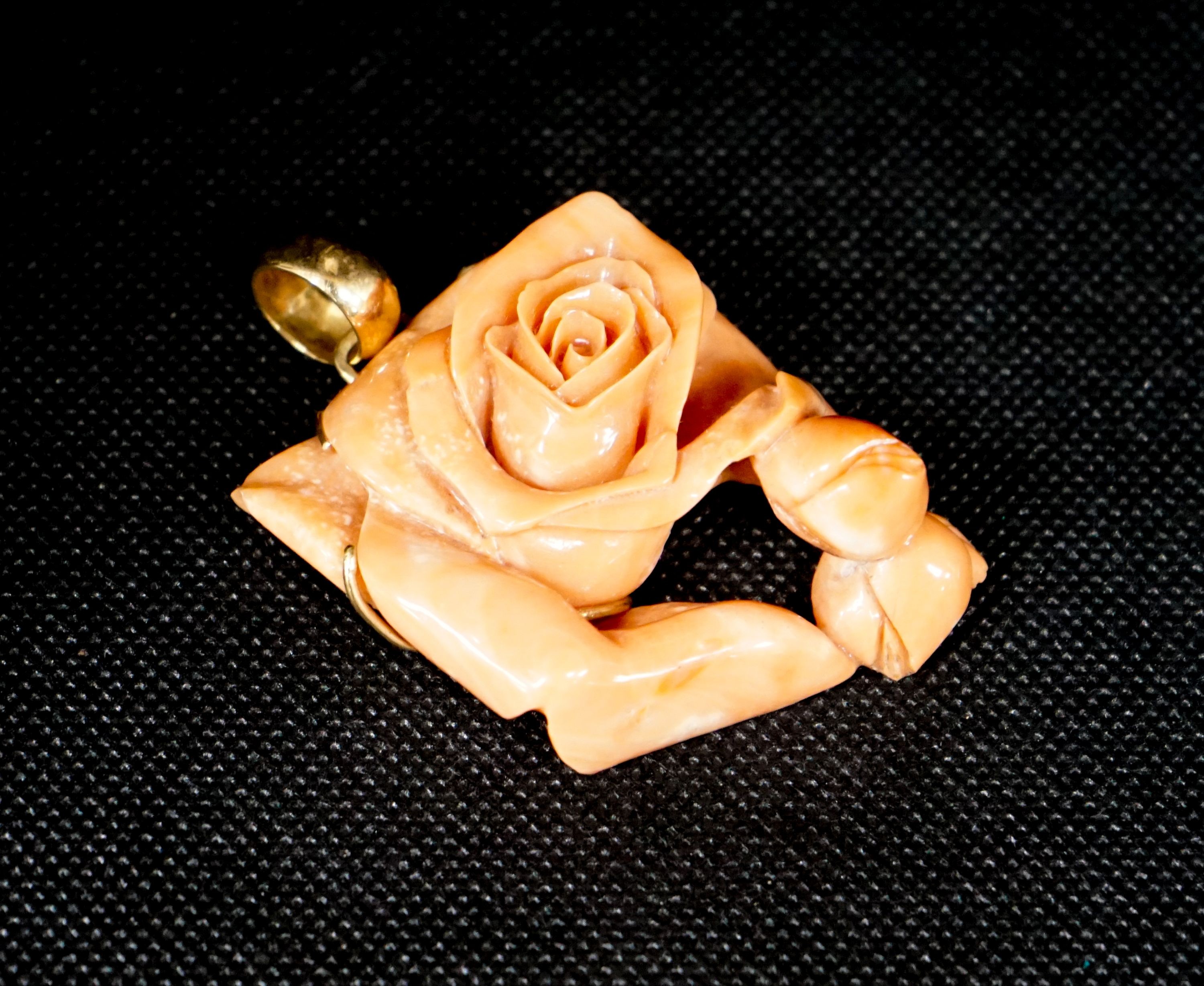 A yellow metal mounted carved coral 'rose' pendant, 49mm, gross weight 40 grams.